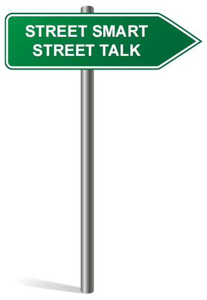 Green street sign with white text reading "STREET SMART STREET TALK," mounted on a silver pole and pointing to the right.